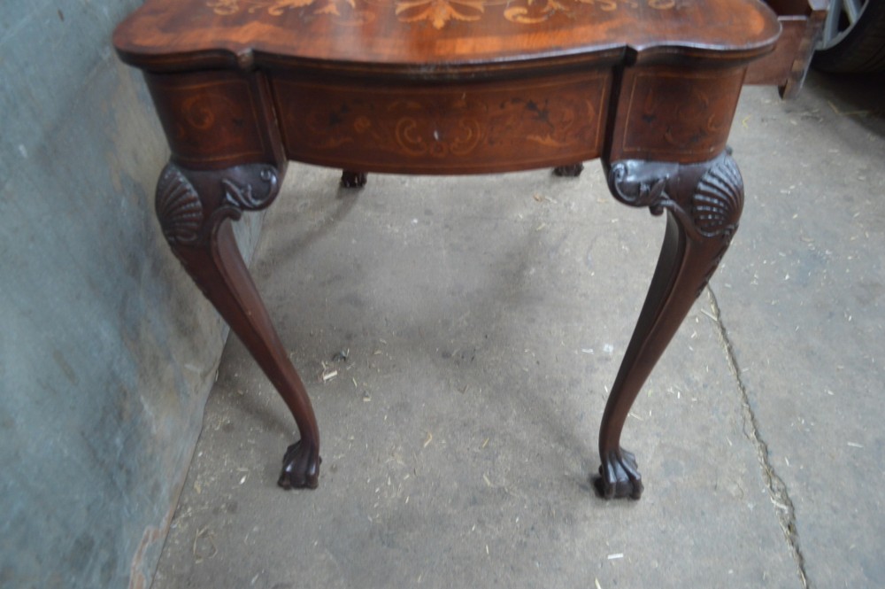 An 18th-century Dutch side table featuring floral marquetry inlay across a serpentine top, supported by cabriole legs with shell-carved knees and claw-and-ball feet. View V