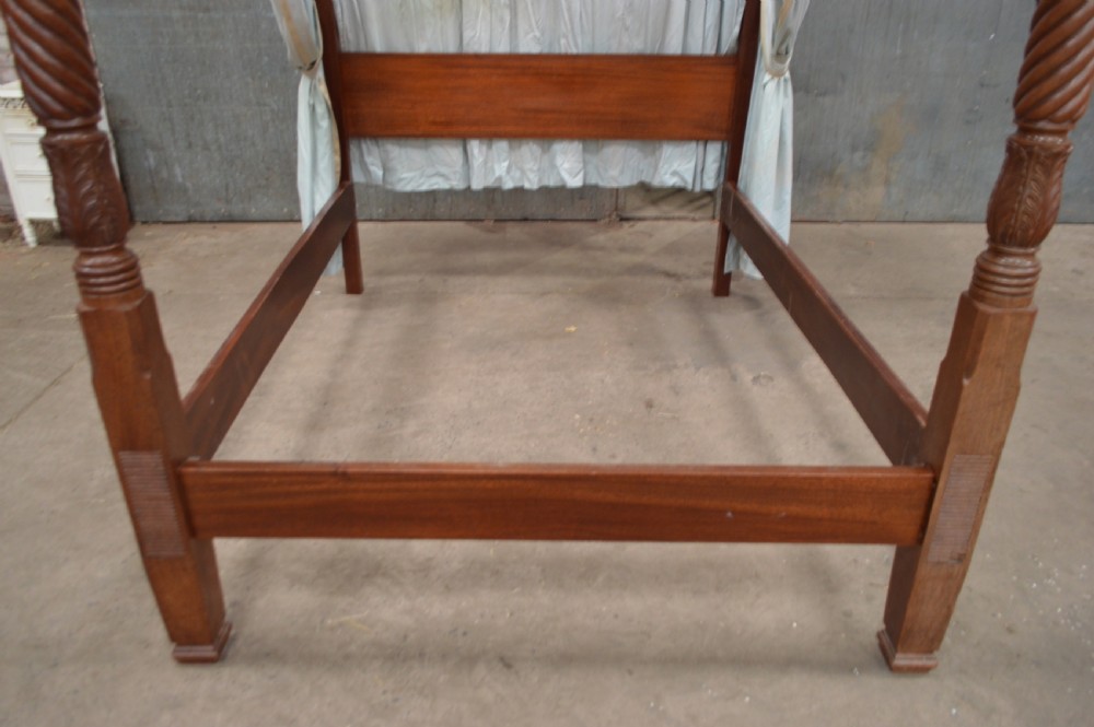 A Victorian mahogany four-poster bed featuring spiral barley-twist carved posts, a plain wooden headboard, and pale blue fabric drapery around the top frame. View III