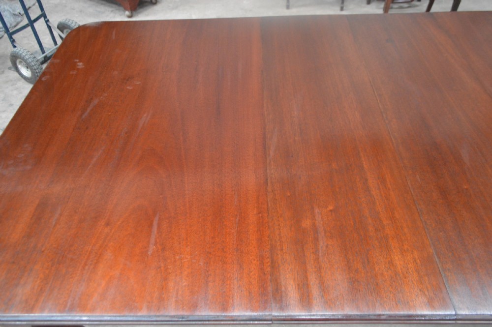A large Victorian mahogany extending dining table with cabriole legs resting on castors. View III