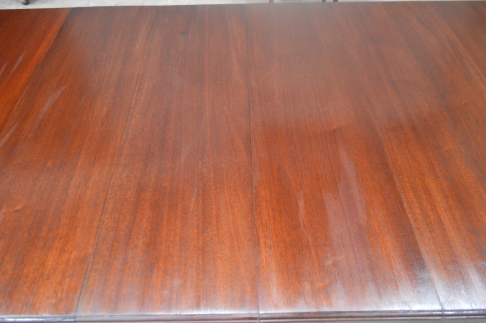 A large Victorian mahogany extending dining table with cabriole legs resting on castors. View IV