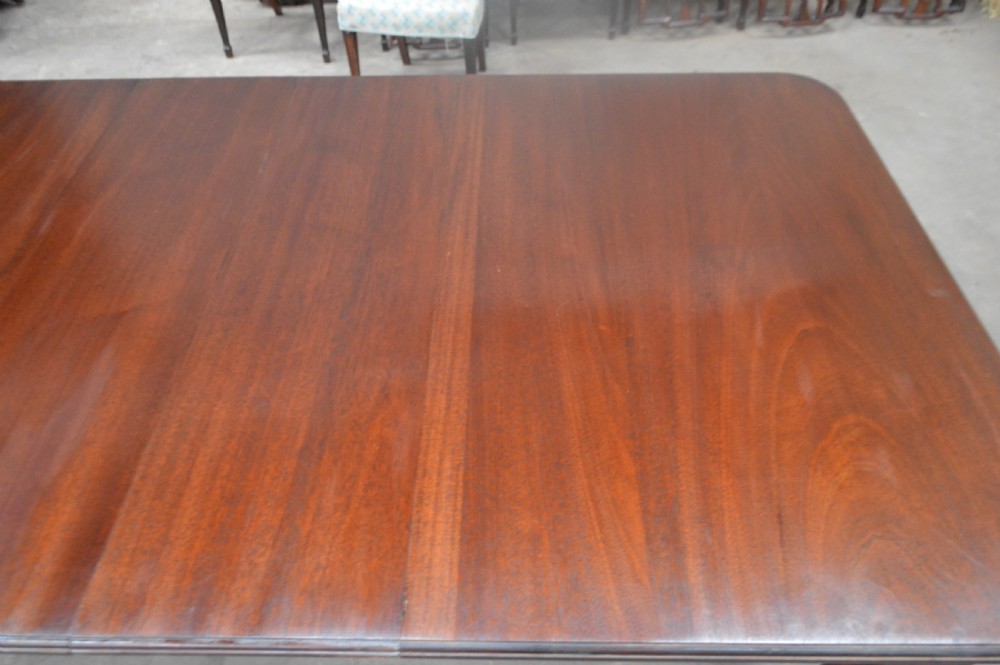 A large Victorian mahogany extending dining table with cabriole legs resting on castors. View V