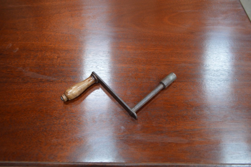 A large Victorian mahogany extending dining table with cabriole legs resting on castors. View VI