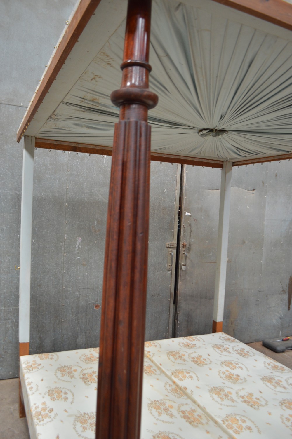 An early Victorian six-foot wide mahogany four poster bed featuring turned front posts and a pleated fabric canopy. View II