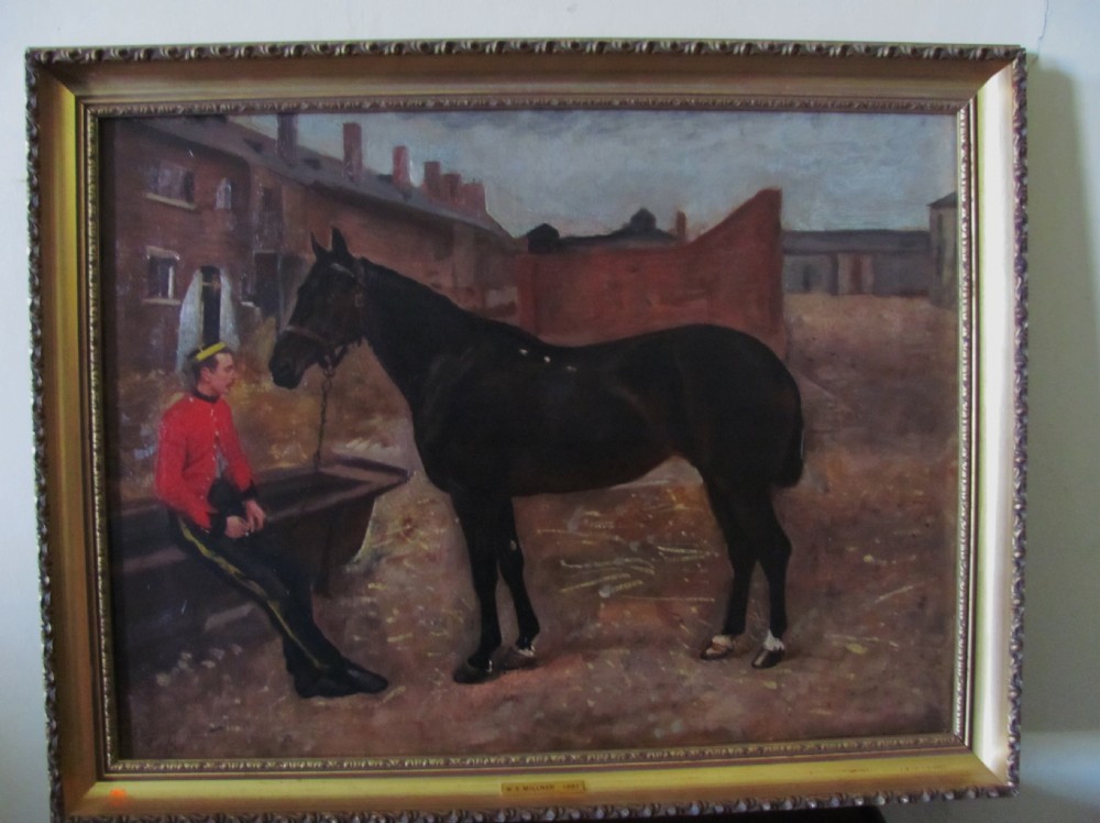 A 19th-century Victorian oil painting depicting a dark bay horse standing beside a seated soldier in a red military tunic, framed in gilt wood.