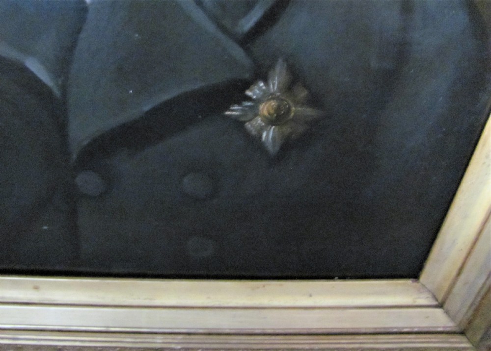 A 19th-century oil painting depicting a gentleman in a dark double-breasted jacket and white cravat, set within an ornate gilt frame decorated with oak leaf mouldings. View II