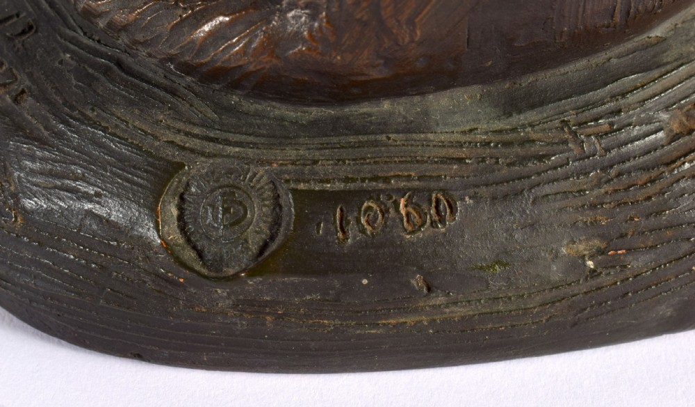 A patinated dark brown terracotta sculpture depicting a seated Alsatian dog on an integral naturalist base, signed by Foucher. View VI
