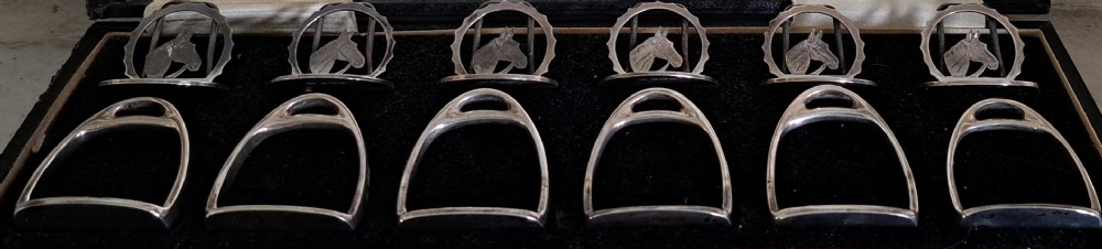 set of six silver napkin rings,and 6 placeholders horses head and stirrups