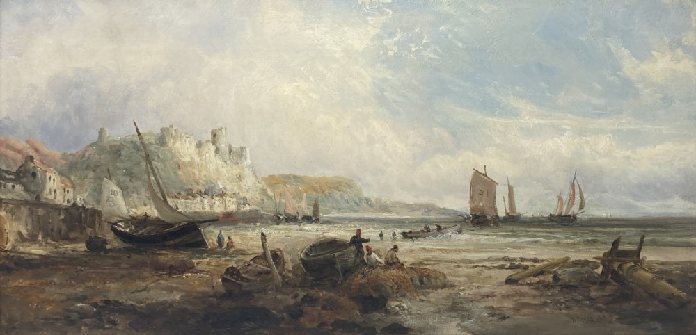 A 19th-century coastal oil painting depicting fishing vessels and figures on a beach below cliffside ruins, enclosed in an ornate gold gilt frame. View III