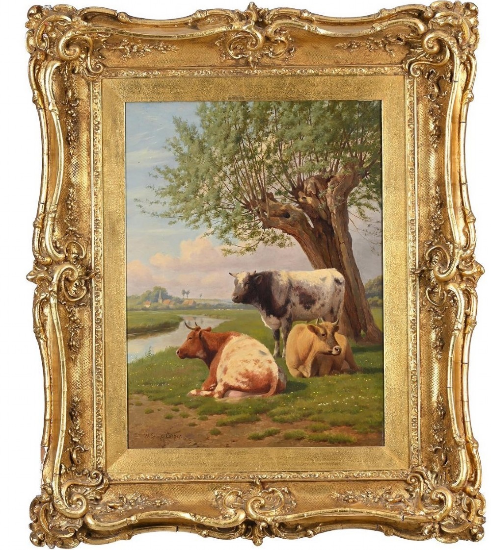 A 19th-century oil painting by William Sidney Cooper depicting three cows resting beside a river under a willow tree, enclosed in a heavily ornamented gold gilt frame.