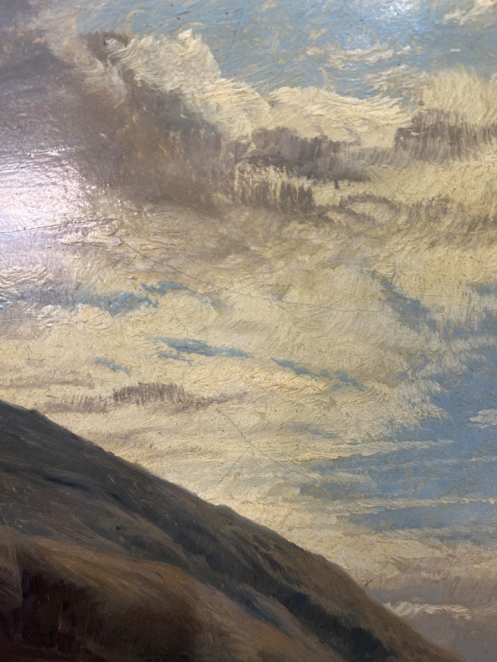 An oil painting depicting sheep grazing in a green valley before mountains, framed in an ornate gilded frame. View III