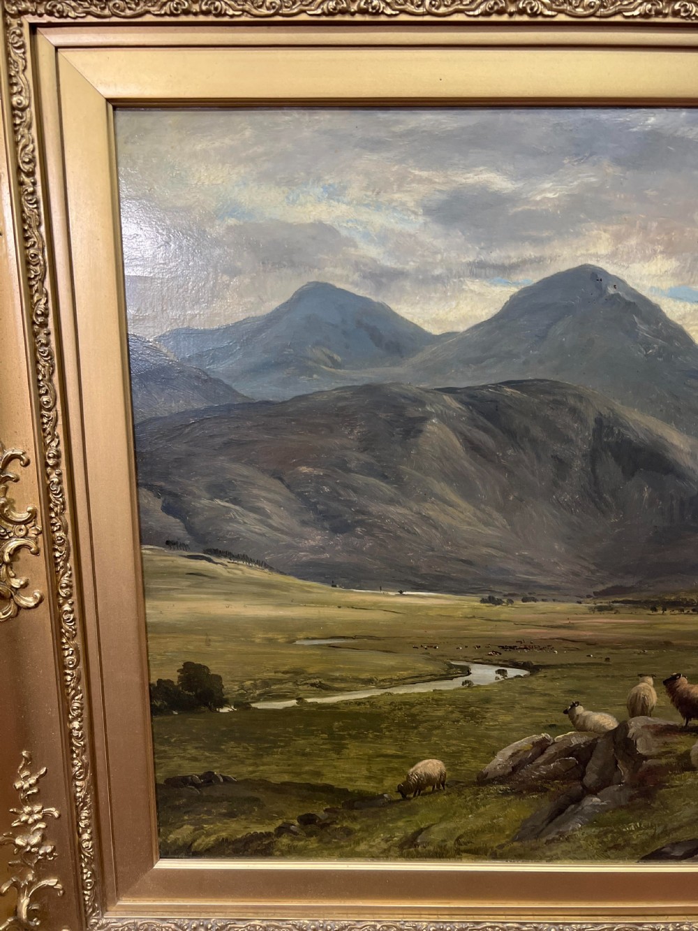An oil painting depicting sheep grazing in a green valley before mountains, framed in an ornate gilded frame. View VI
