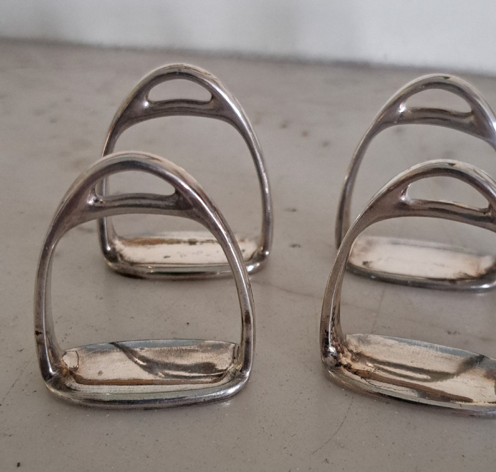 A set of six silver napkin rings modelled in the shape of traditional horse riding stirrups. View II