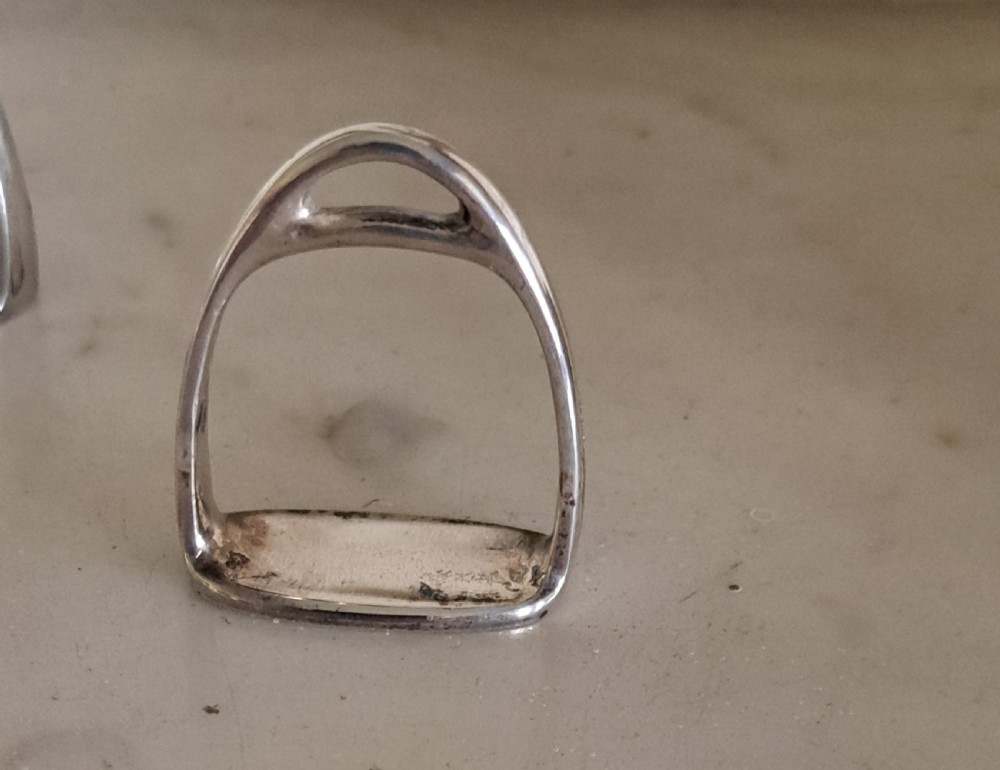 A set of six silver napkin rings modelled in the shape of traditional horse riding stirrups. View III