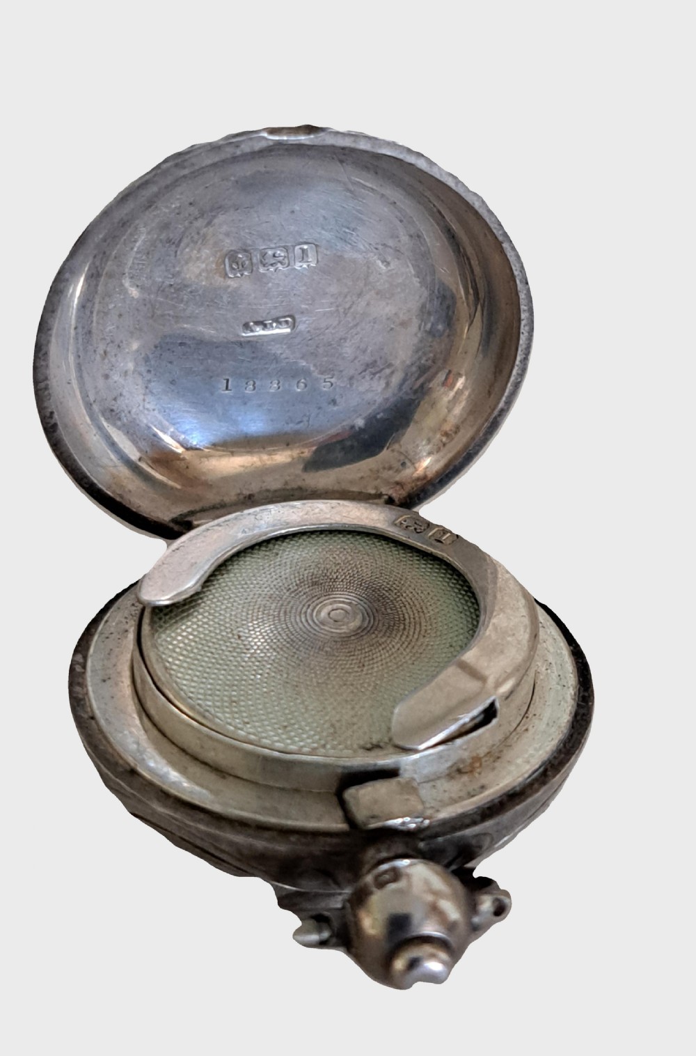 A circular Edwardian sterling silver single sovereign case featuring foliate scroll engraving and a central unengraved cartouche. View III