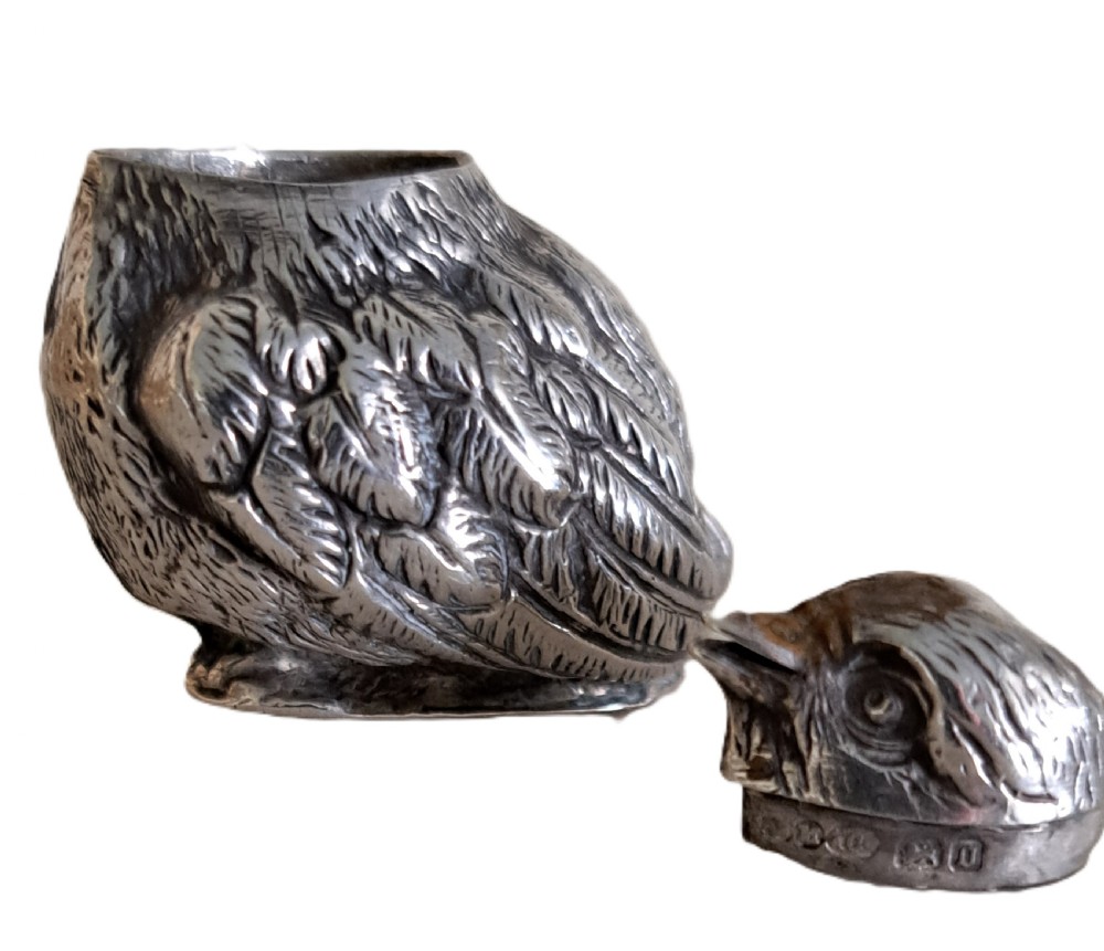 A pair of sterling silver condiment pots sculpted in the form of newly hatched chicks with textured feather detailing. View X