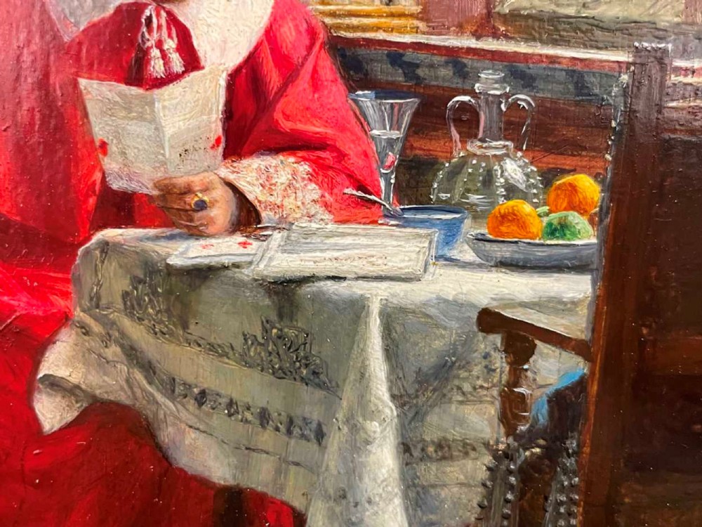 An antique oil painting depicting a cardinal in red robes seated at a table beside a leaded glass window, set within an ornate gilded frame. View VII