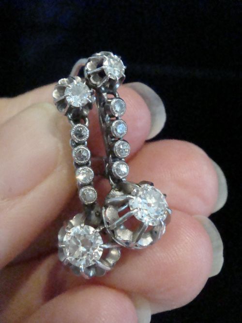 fig 2. A pair of French Edwardian platinum and diamond drop earrings featuring transitional cut diamonds suspended in articulated settings.