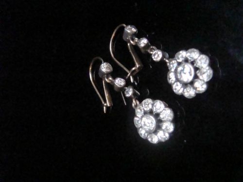 fig 3. A pair of Edwardian silver and gold drop earrings featuring articulated strands of old cut diamonds leading to floral cluster drops.