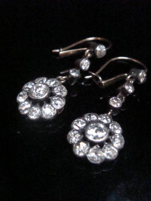 fig 2. A pair of Edwardian silver and gold drop earrings featuring articulated strands of old cut diamonds leading to floral cluster drops.