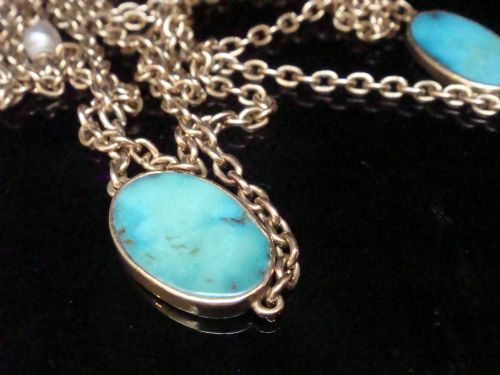 fig 1. An Edwardian 15ct yellow gold longuard chain featuring oval turquoise cabochons set in collet mounts interspersed with natural pearls.