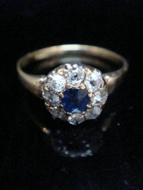 fig 1. An Edwardian 18ct gold ring featuring a central cushion-cut blue sapphire encircled by a halo of old-cut diamonds.