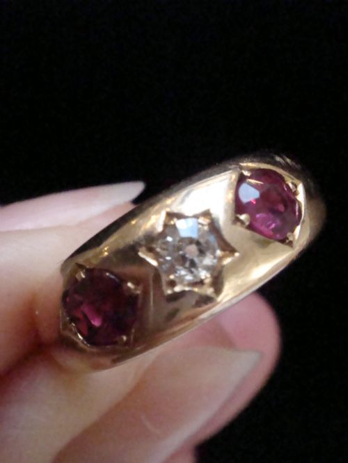 fig 1. An Edwardian 18ct yellow gold gypsy band ring set with a central old cut diamond flanked by two rubies in star-shaped recessed mountings.