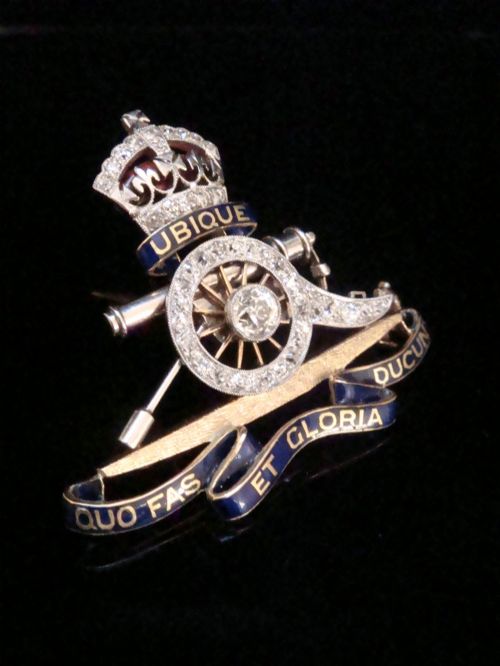 fig 3. An Edwardian platinum and gold Royal Artillery badge brooch featuring blue guilloche enamel mottos and diamond settings.