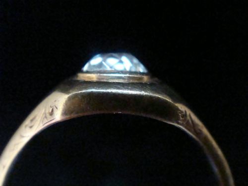 fig 2. A Victorian 18ct yellow gold gypsy ring set with a single old cut diamond in a flush rubover bezel with hand engraving.