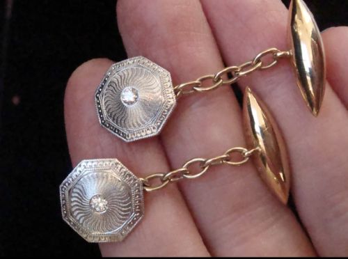 fig 1. A pair of Edwardian cufflinks featuring octagonal platinum faces with engine-turned sunburst detailing and central old-cut diamonds, connected by chains to yellow gold torpedo backs.