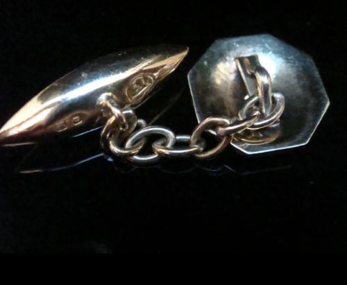 A pair of Edwardian cufflinks featuring octagonal platinum faces with engine-turned sunburst detailing and central old-cut diamonds, connected by chains to yellow gold torpedo backs. View IV