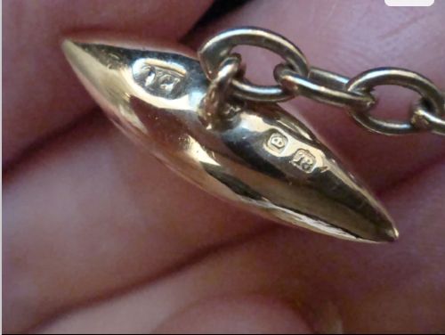 A pair of Edwardian cufflinks featuring octagonal platinum faces with engine-turned sunburst detailing and central old-cut diamonds, connected by chains to yellow gold torpedo backs. View VI