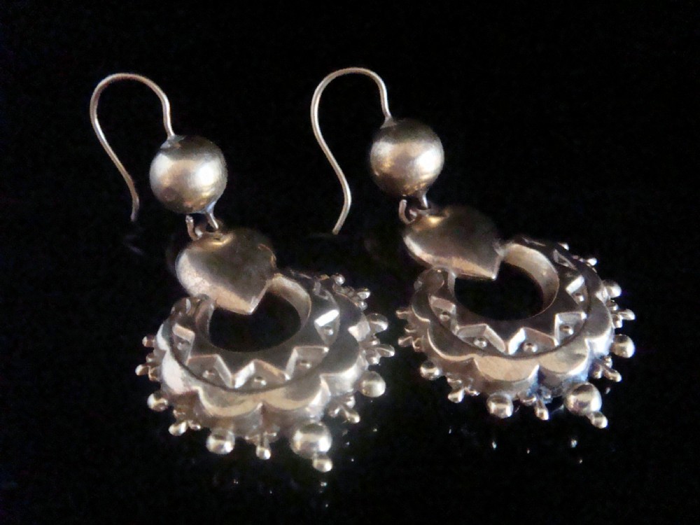 A pair of antique Victorian gold drop earrings featuring French hook wires, spherical accents, puff hearts, and ornate scalloped drops with granulated edging.