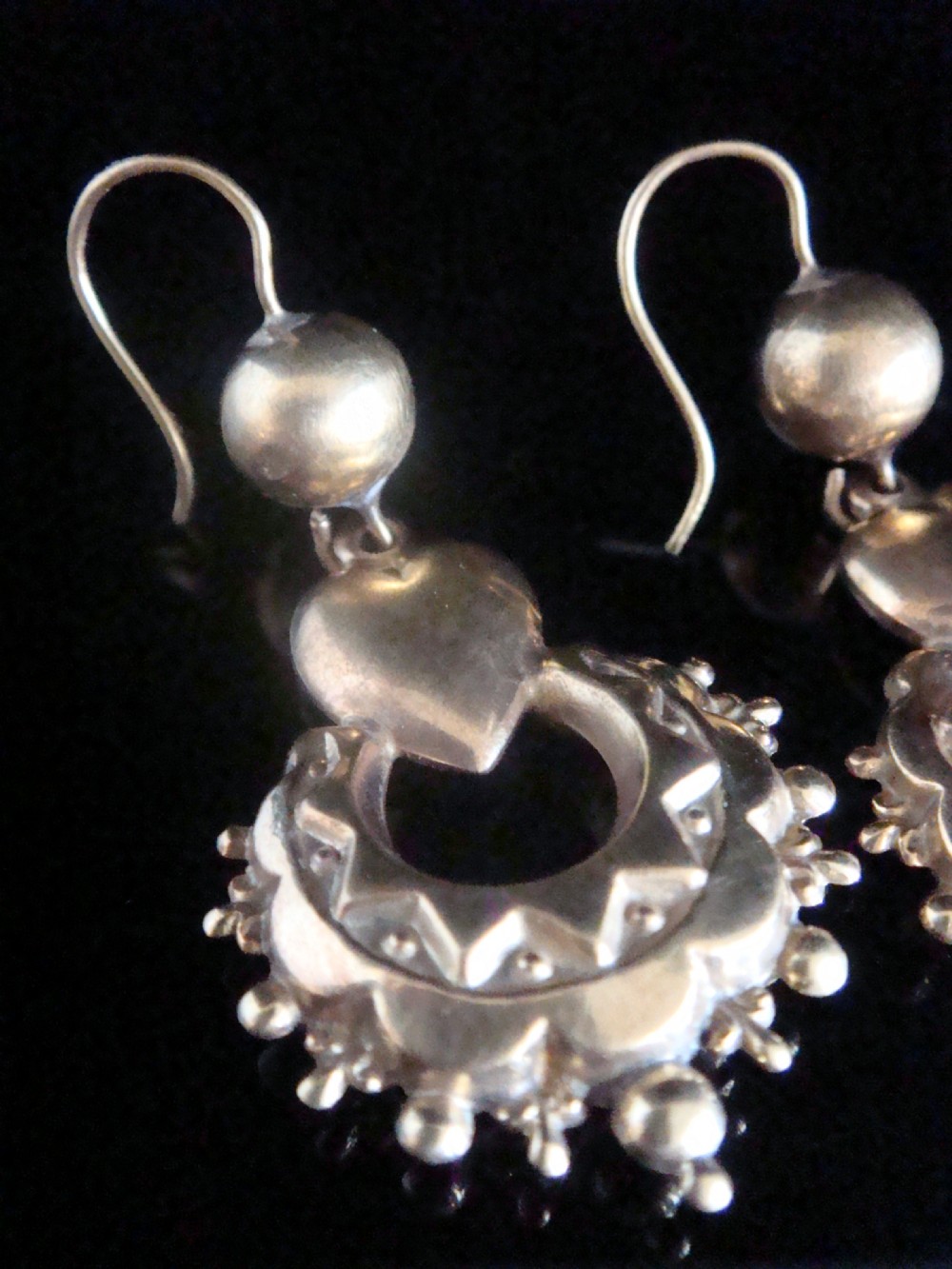 A pair of antique Victorian gold drop earrings featuring French hook wires, spherical accents, puff hearts, and ornate scalloped drops with granulated edging. View II