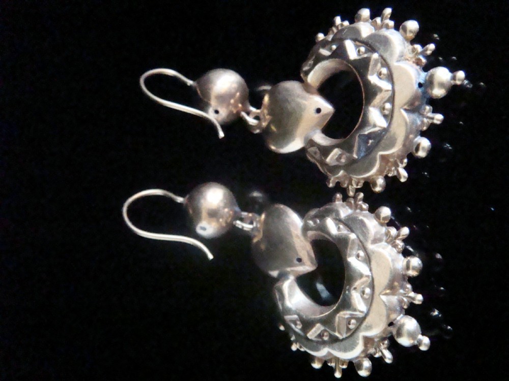 A pair of antique Victorian gold drop earrings featuring French hook wires, spherical accents, puff hearts, and ornate scalloped drops with granulated edging. View III