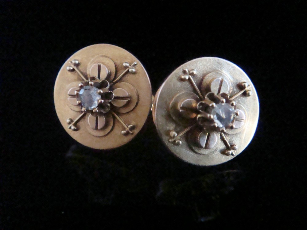 A pair of circular 18ct yellow gold Art Nouveau stud earrings, each featuring a central claw-set rose-cut diamond within a layered geometric floral motif.