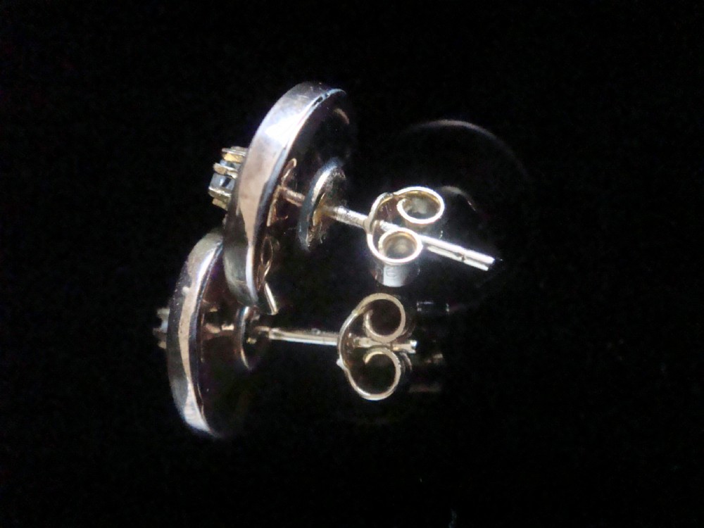 A pair of circular 18ct yellow gold Art Nouveau stud earrings, each featuring a central claw-set rose-cut diamond within a layered geometric floral motif. View II