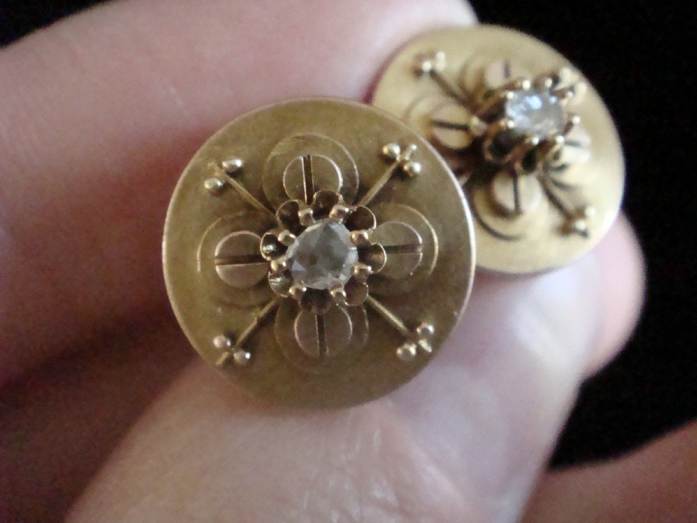 A pair of circular 18ct yellow gold Art Nouveau stud earrings, each featuring a central claw-set rose-cut diamond within a layered geometric floral motif. View III