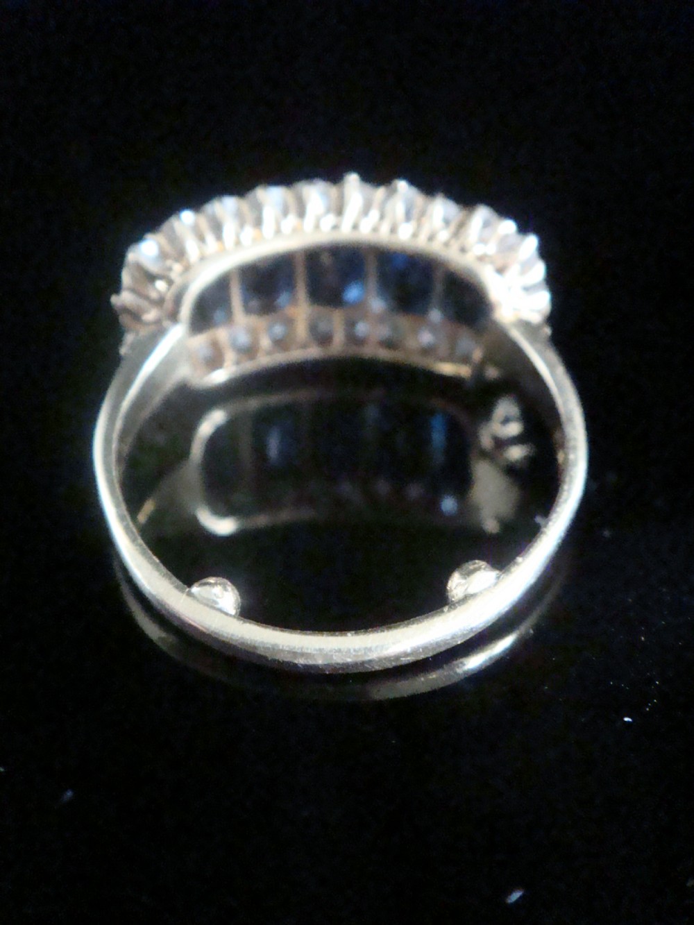 An 18ct yellow gold Victorian boat ring featuring central sapphires framed by a border of small round diamonds. View II