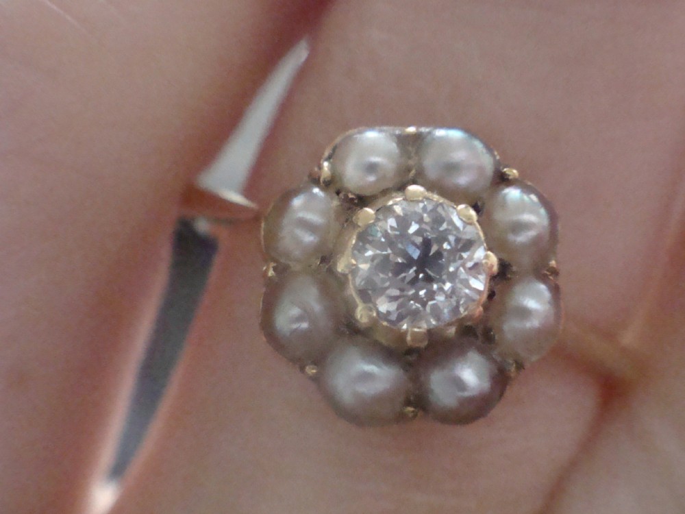 An Edwardian 18ct yellow gold cluster ring featuring a central old cut diamond surrounded by eight small pearls. View III