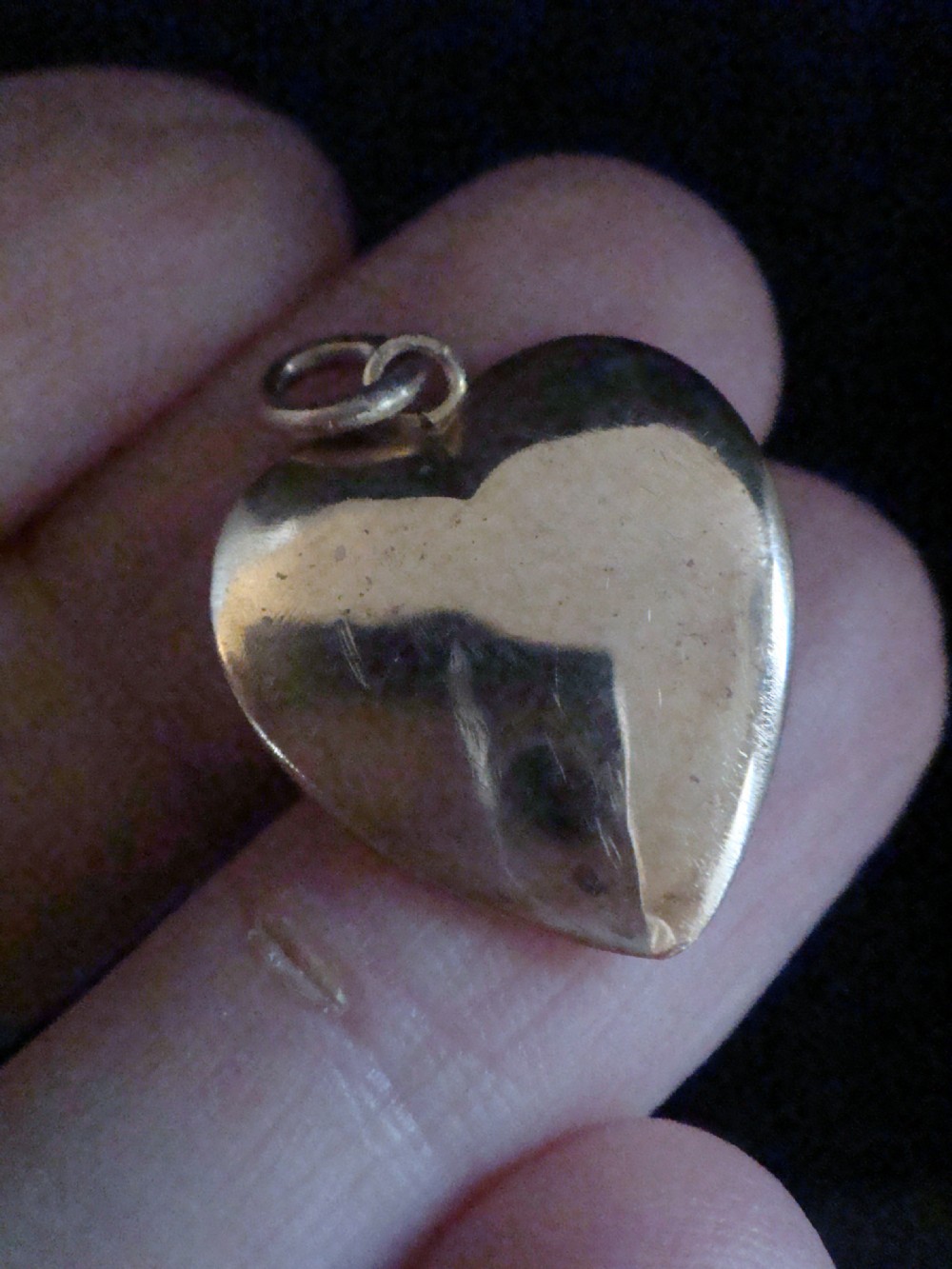 A Victorian heart-shaped 15ct gold pendant featuring a matte finish and a central starburst setting holding a single white seed pearl. View III