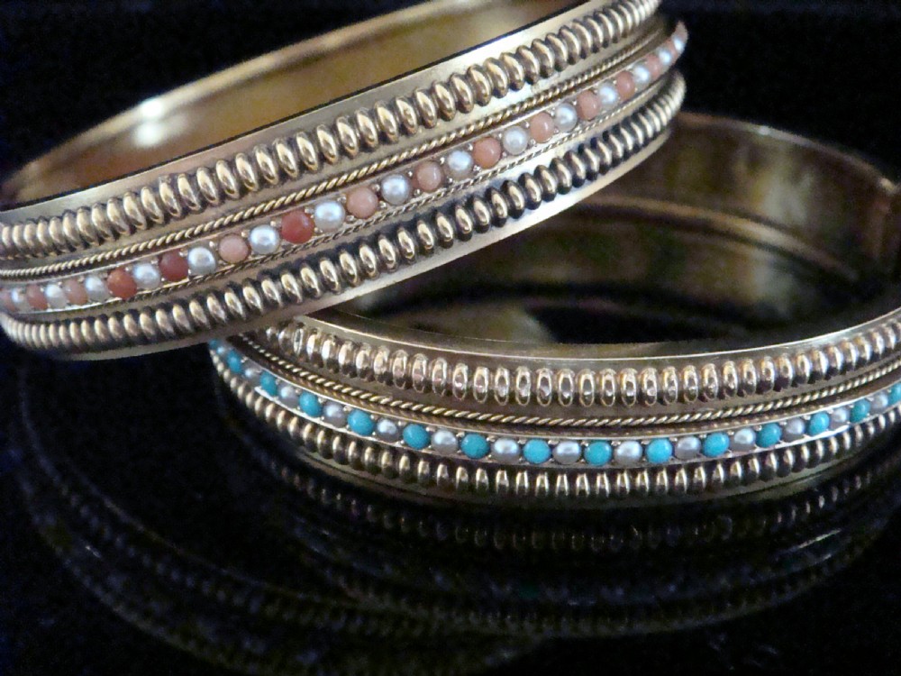 A pair of Victorian 15ct gold bangles featuring beaded borders and central rows of alternating seed pearls, coral, and turquoise cabochons. View II