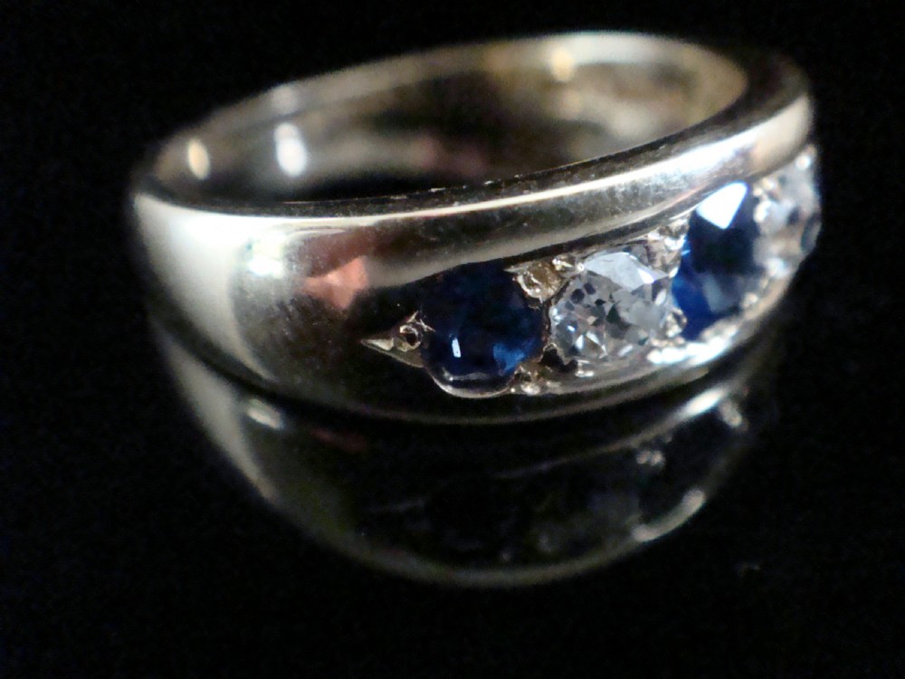 A Victorian 18ct yellow gold gypsy ring set with five alternating blue sapphires and old cut diamonds flush inside a wide band. View III