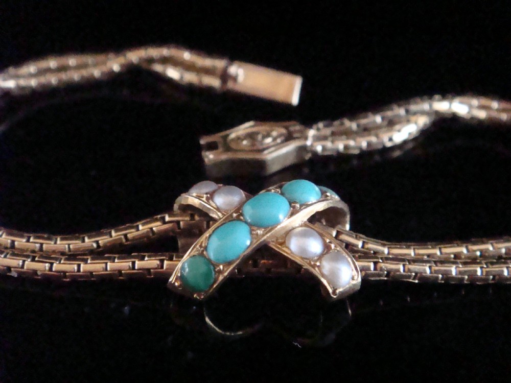 A Victorian 15ct rose gold double snake chain bracelet featuring a central lovers knot set with turquoise cabochons and pearls. View II