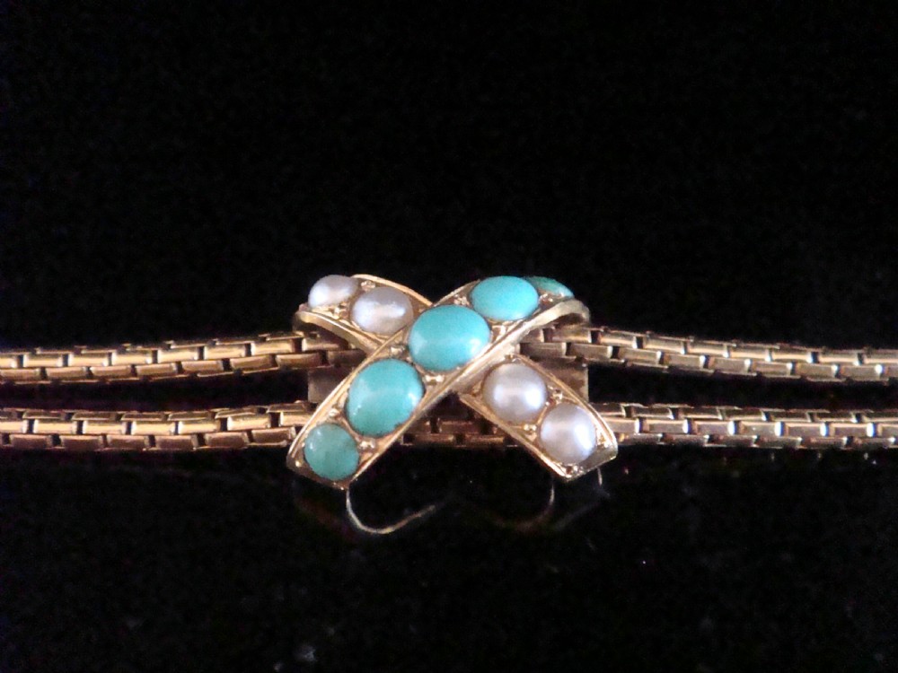 A Victorian 15ct rose gold double snake chain bracelet featuring a central lovers knot set with turquoise cabochons and pearls. View III