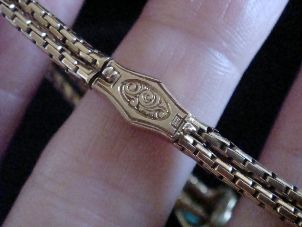 A Victorian 15ct rose gold double snake chain bracelet featuring a central lovers knot set with turquoise cabochons and pearls. View IV
