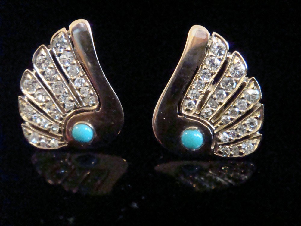A pair of 1950s fan-shaped 18ct gold earrings set with round turquoise cabochons and rows of eight-cut diamonds.