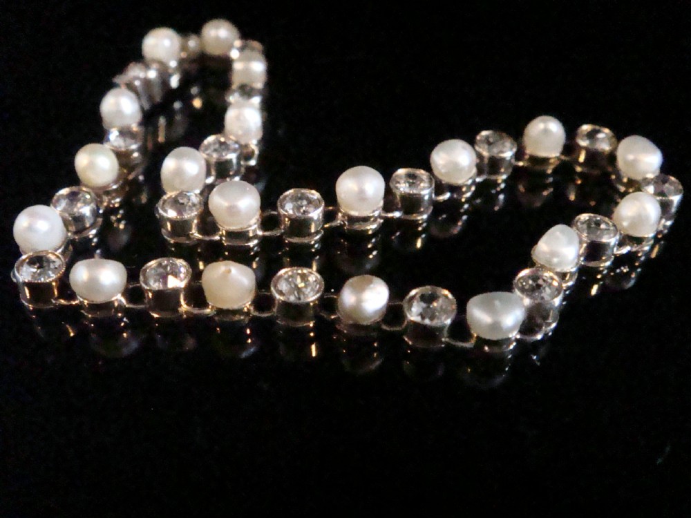 An antique French Edwardian 18ct white gold line bracelet featuring an alternating sequence of natural saltwater pearls and circular-cut diamonds. View III