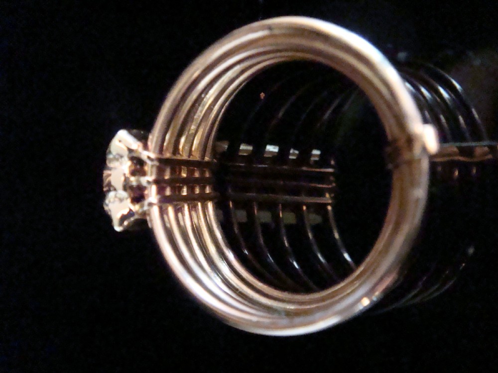 An Edwardian five-row rose gold harem ring featuring a vertical rectangular bar set with central diamonds flanked by blue sapphires. View III