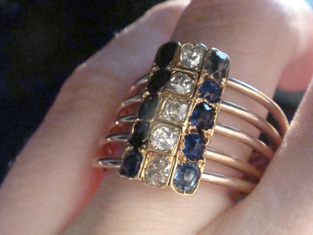 An Edwardian five-row rose gold harem ring featuring a vertical rectangular bar set with central diamonds flanked by blue sapphires. View V