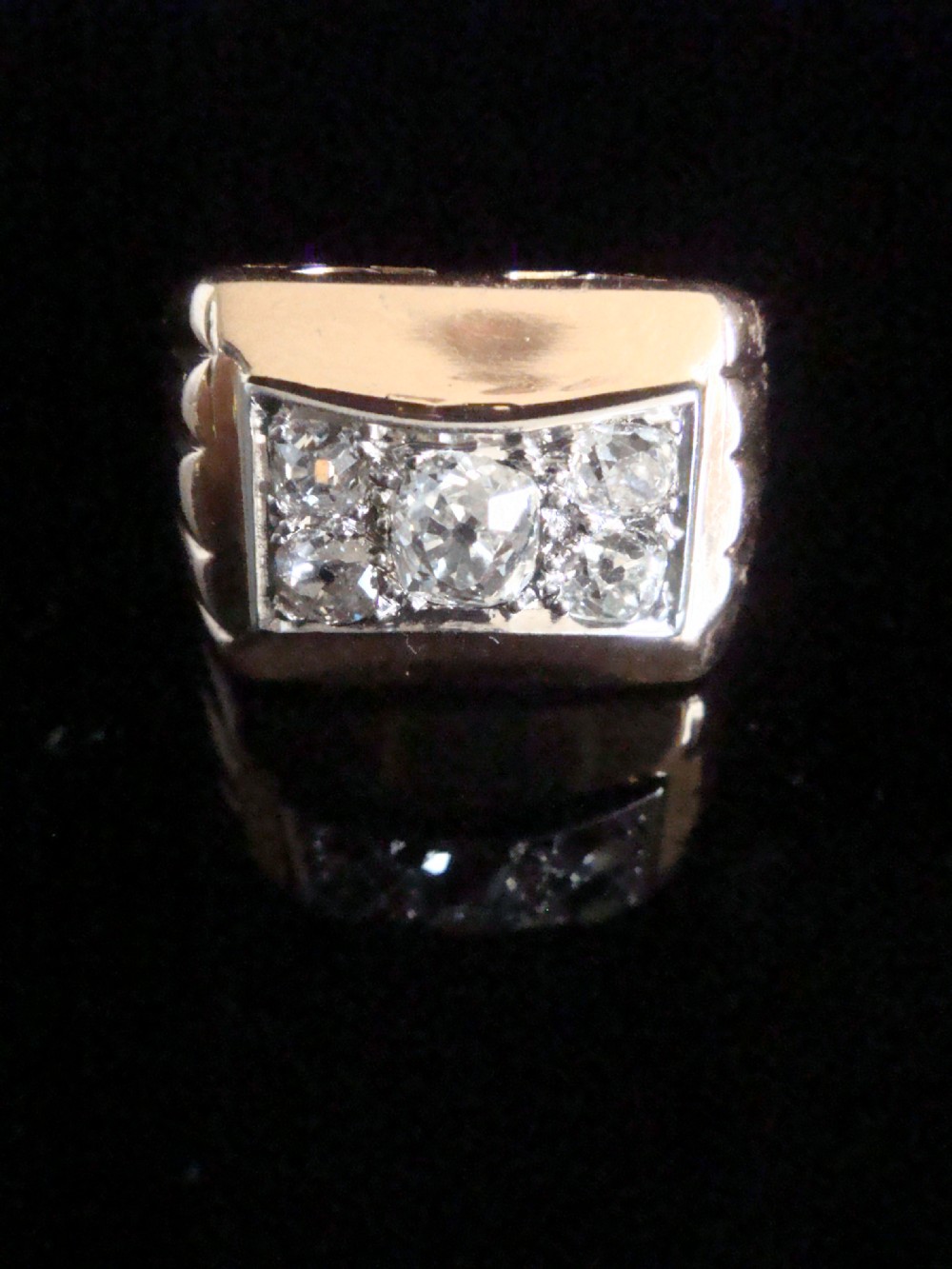 An 18ct yellow gold tank ring featuring a rectangular platinum panel set with bright diamonds.